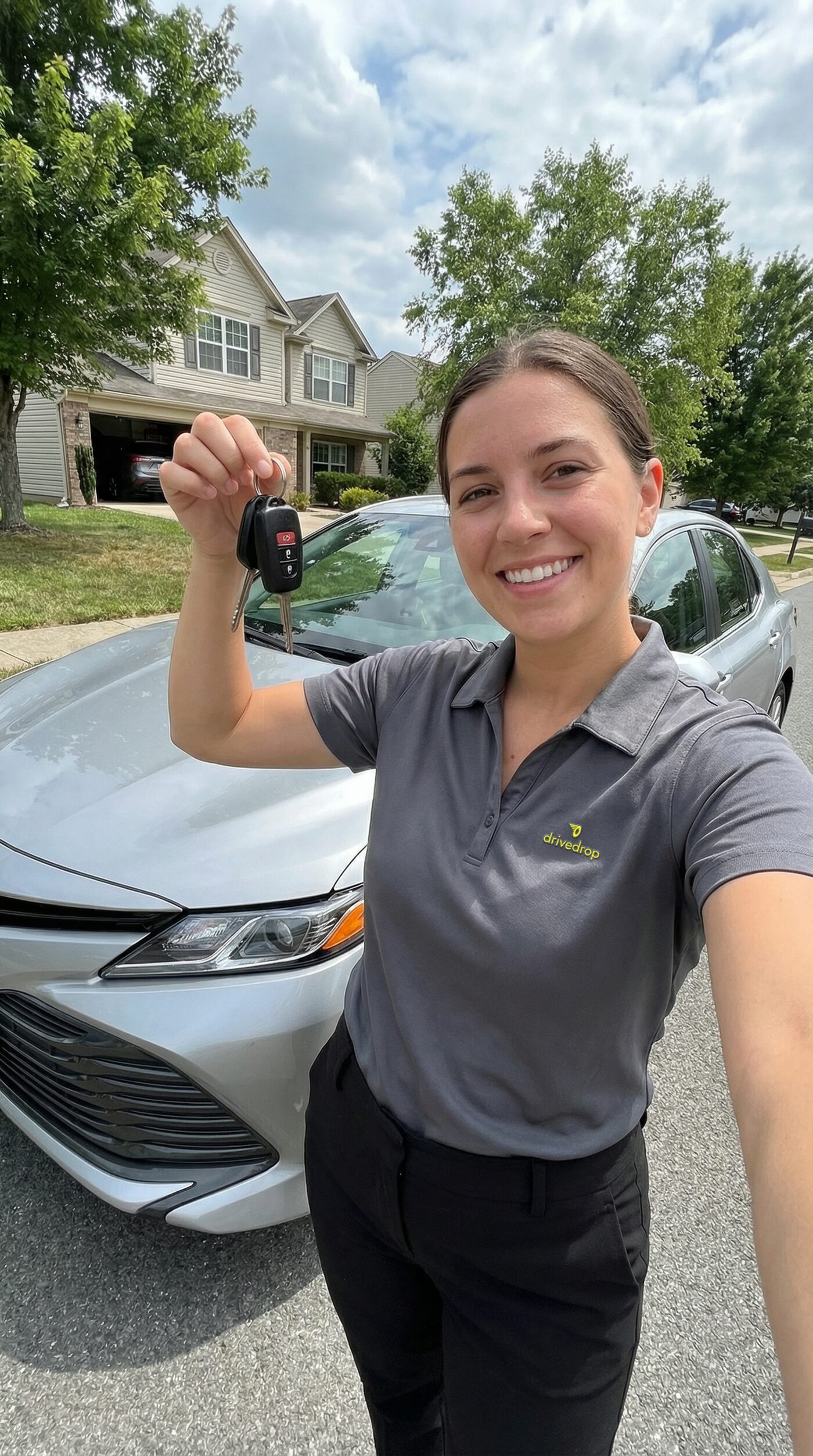 Happy customer receiving keys from DriveDrop professional